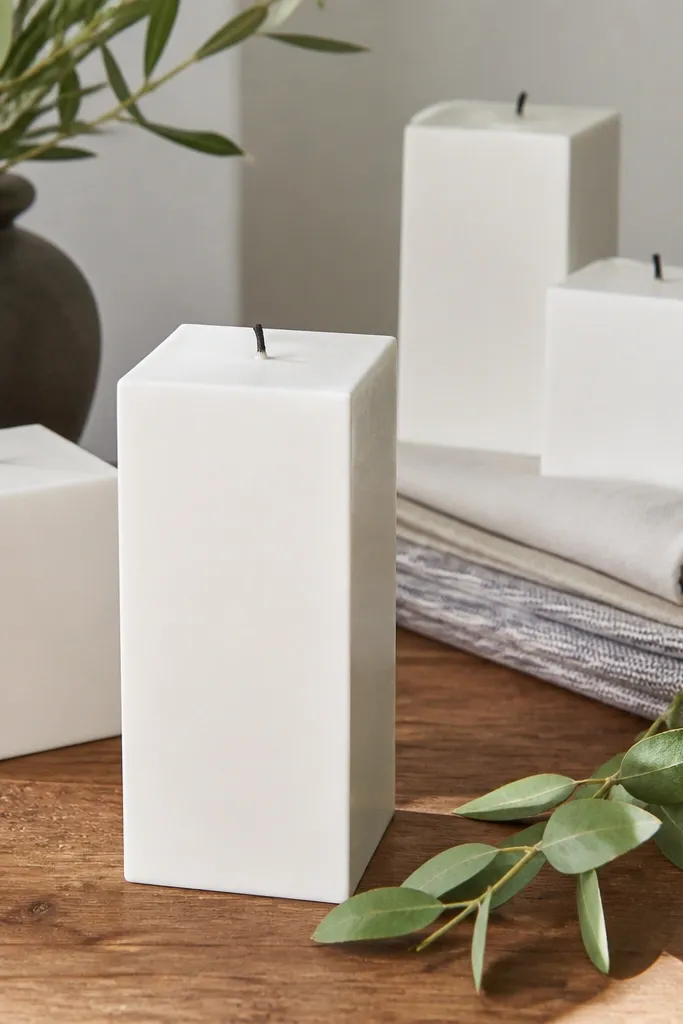Matte white candle blocks with one small greenery sprig