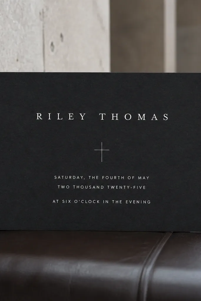 Charcoal wedding card with white text and a simple cross divider line