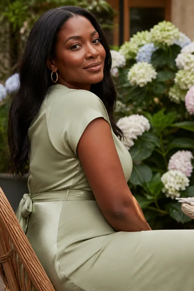 Sage midi dress with a defined waist, paired with gold hoops and nude sandals