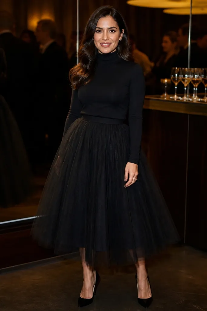 Black tulle midi skirt with a fitted long-sleeve top and black boots