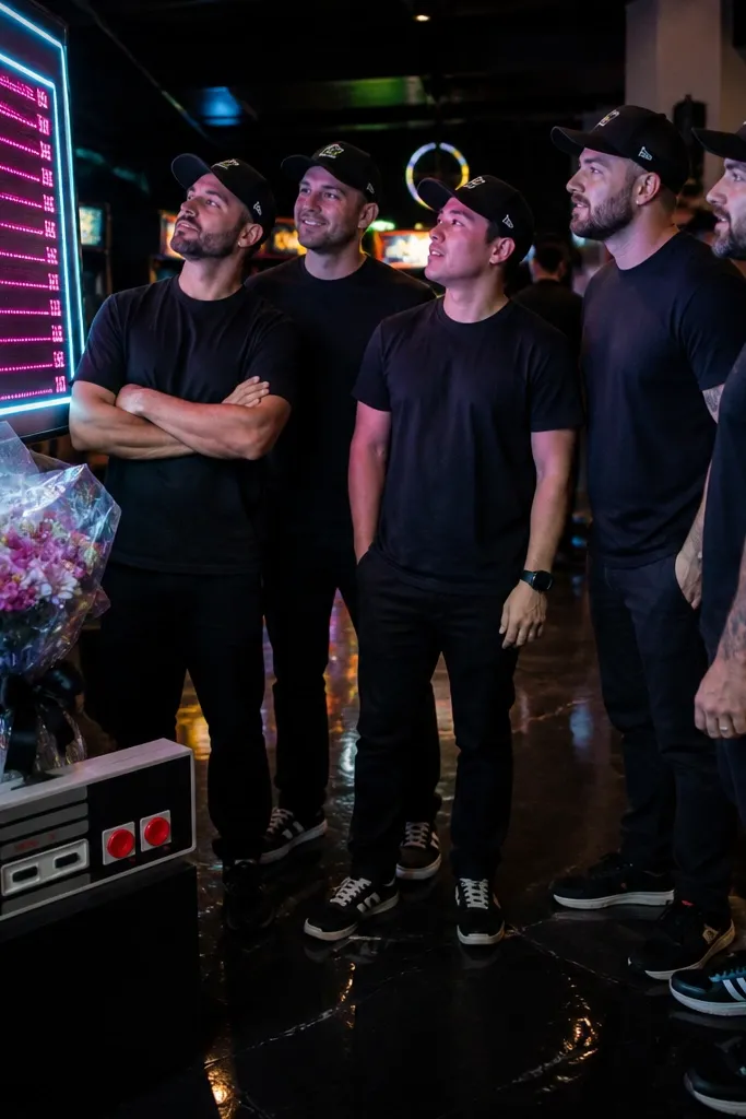 Neon arcade with a scoreboard-style sign and a controller-shaped flower bouquet