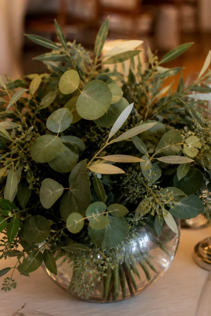 Artificial-looking greenery spread across a table runner