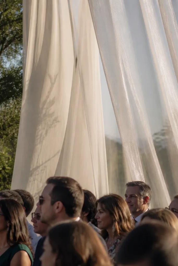 Sheer curtain panels in two textures behind the couple area