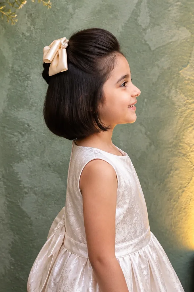 Short bob with a small rolled section pinned at the back and a bow