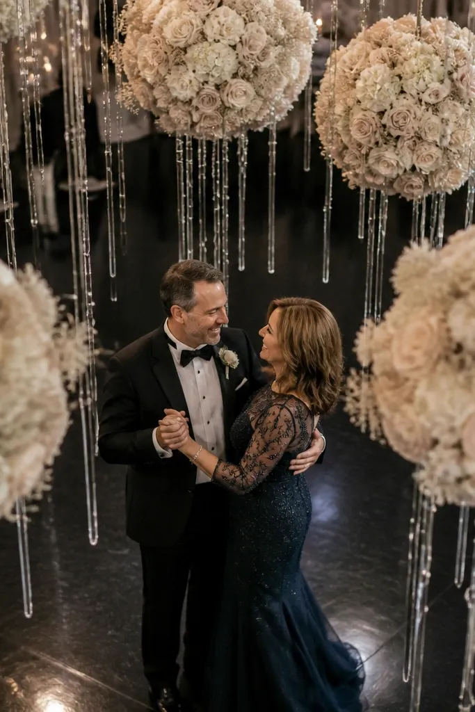 Hanging floral spheres with clear ribbon strands above the dance stage