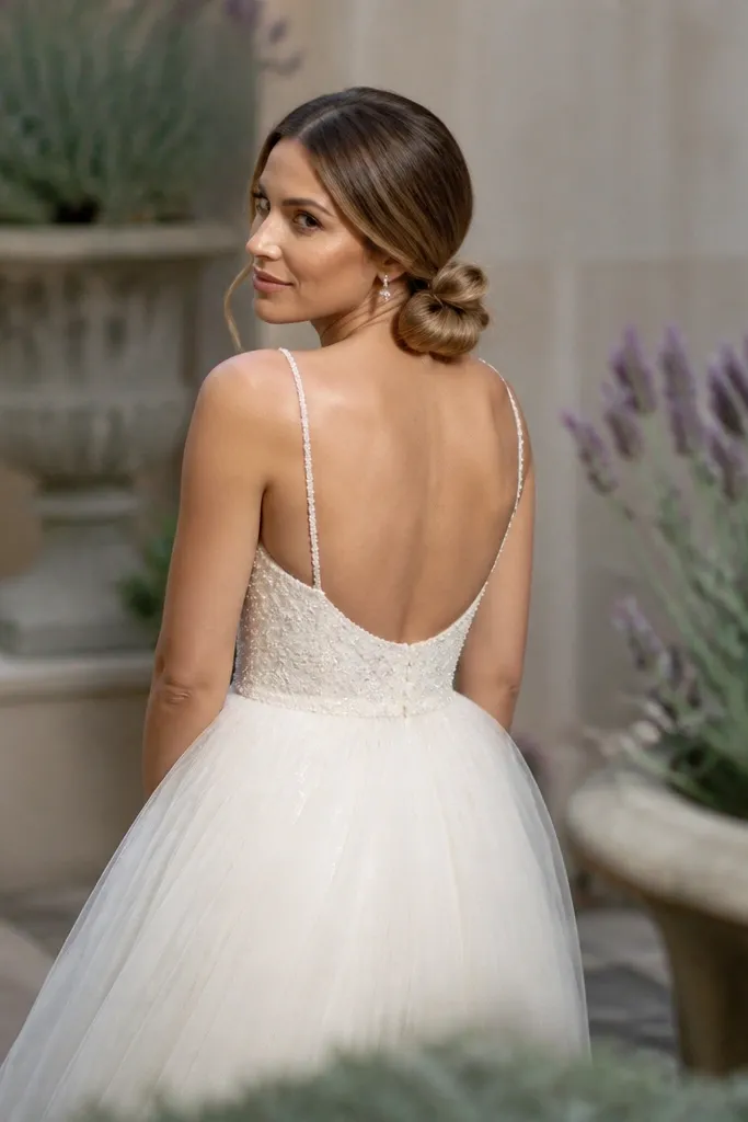 Loose low bun with a bow-like wrap detail at the nape