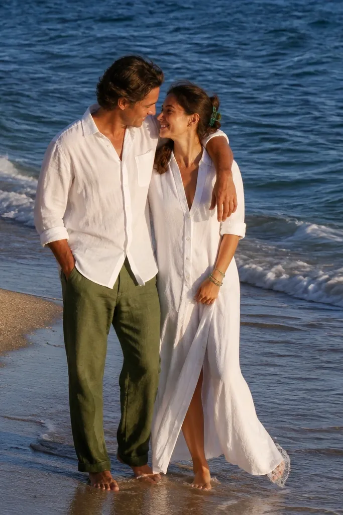 White shirts with sea-glass green accents at a wet sand tide line