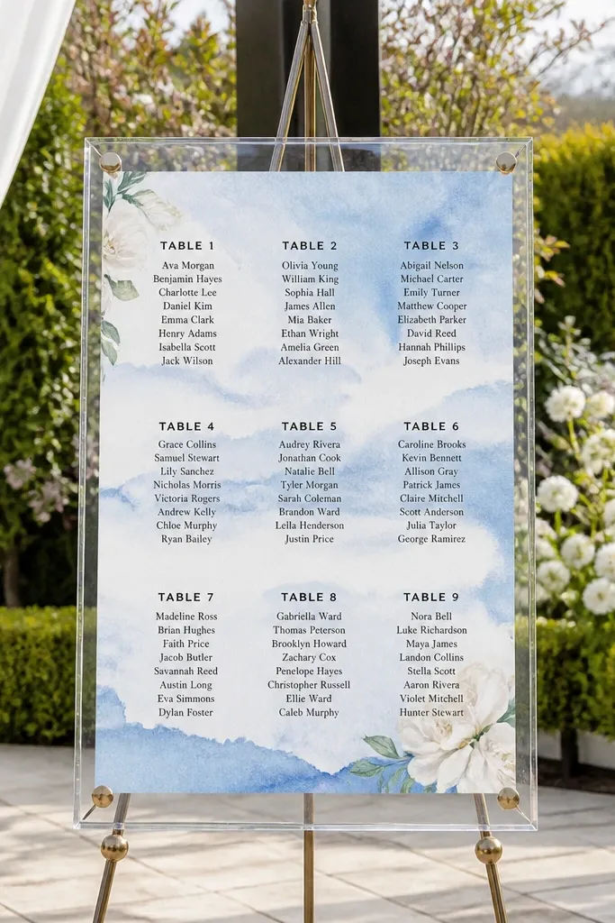 Sky-blue watercolor seating chart pages under a clear acrylic cover.
