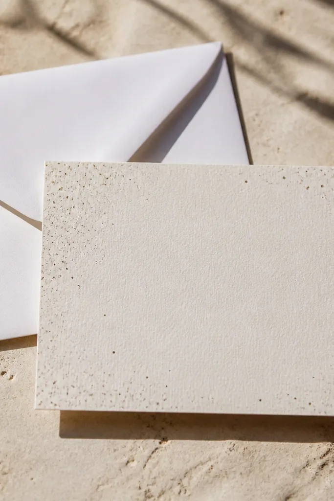 Ivory background with tiny scattered gray and gold specks.