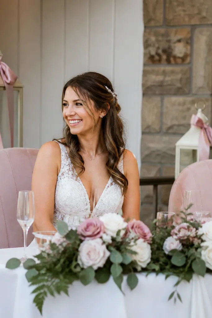 Two tall white lanterns on stage corners with blush ribbon tied to handles