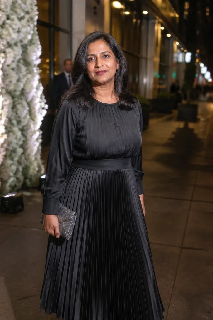 Black and gunmetal satin pleated midi dress with a smooth sheen