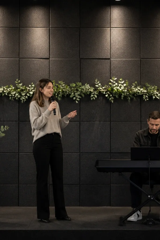 Light wood acoustic panel wall with a narrow greenery strip across the center