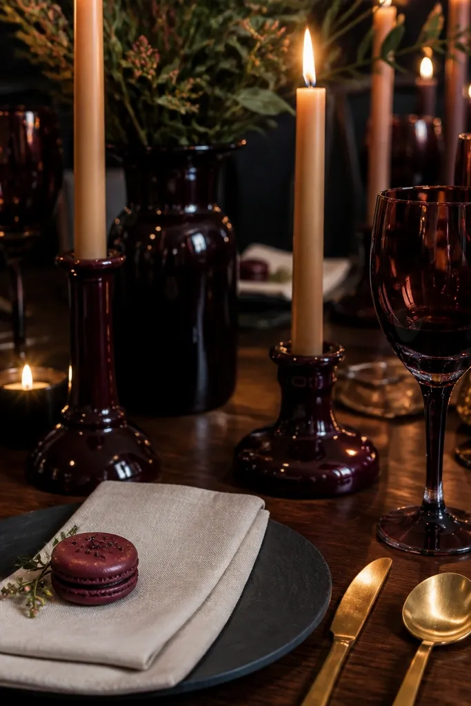 Black cherry napkins with antique gold cutlery and deep red blooms on a cream tablecloth