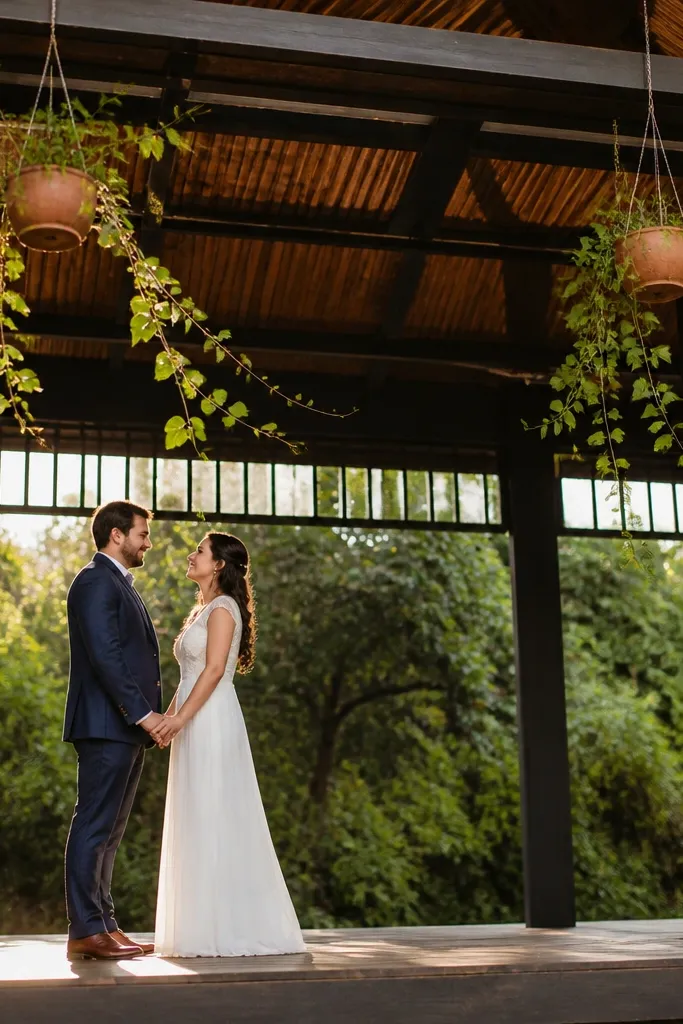 Hanging planters with trailing green vines behind an open wedding stage