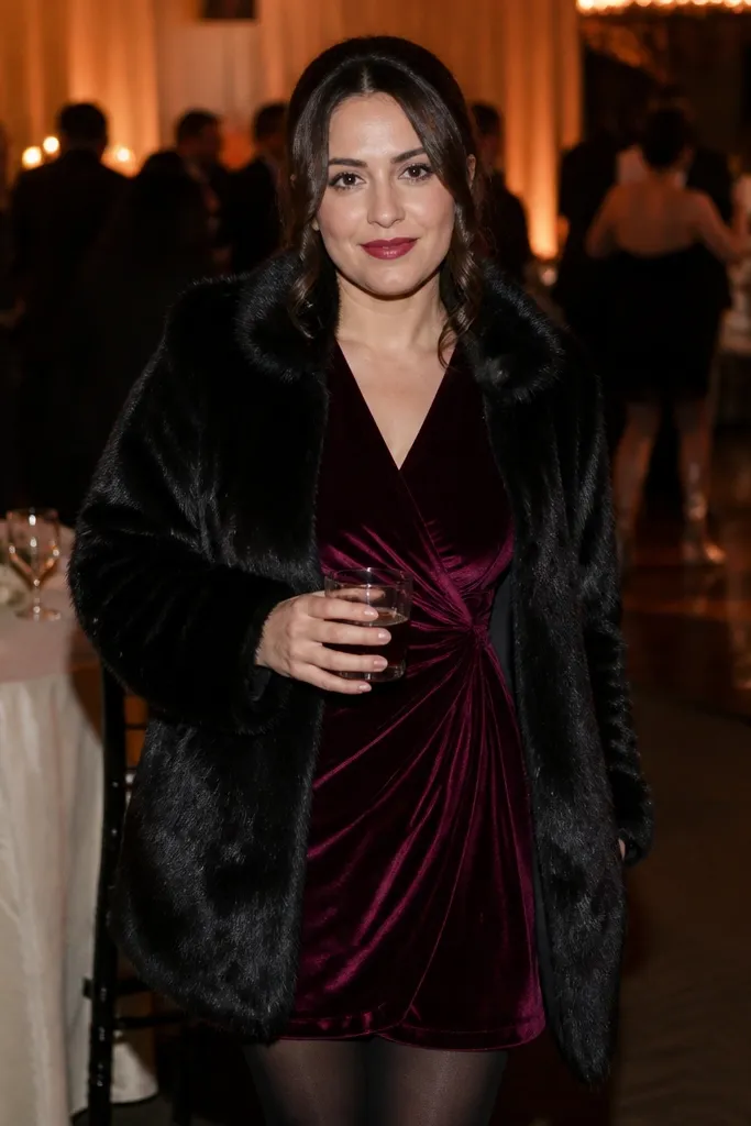 Wine velvet wrap dress with black tights and a short black faux-fur coat