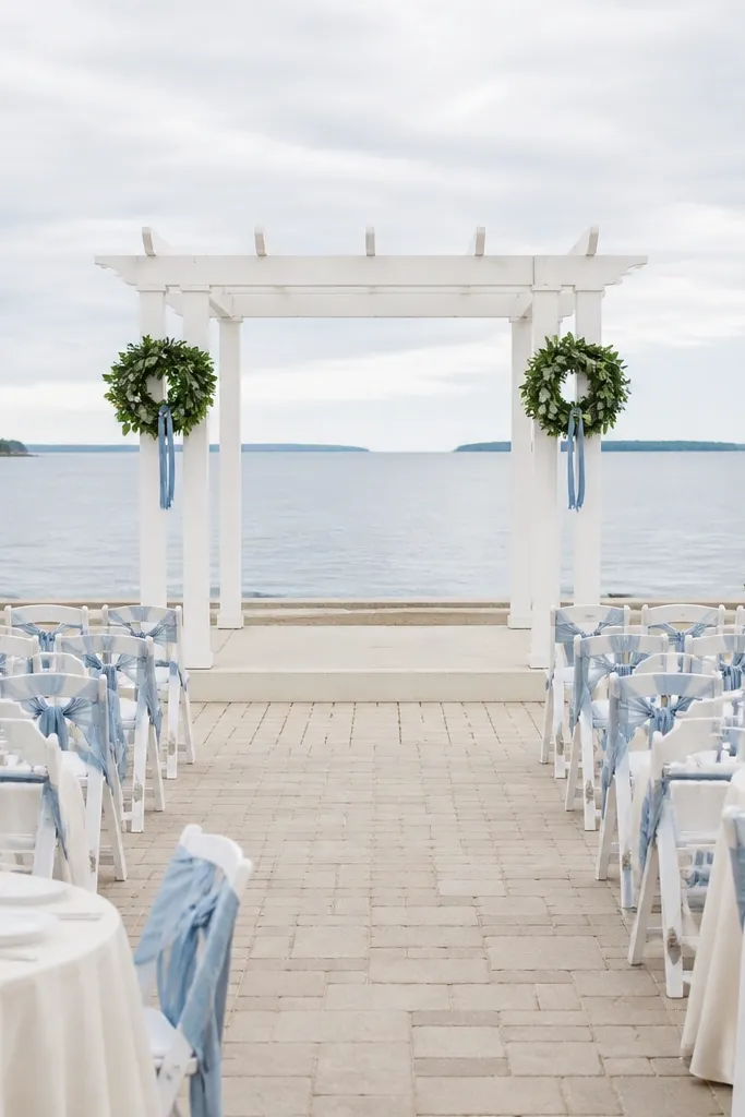 Olive linens, light blue napkins, cream plates, and airy white-blue florals